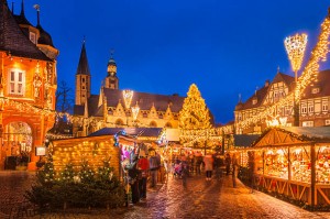 The traditional Christmas Market on the historic Market Square of Goslar, Germany at dusk.